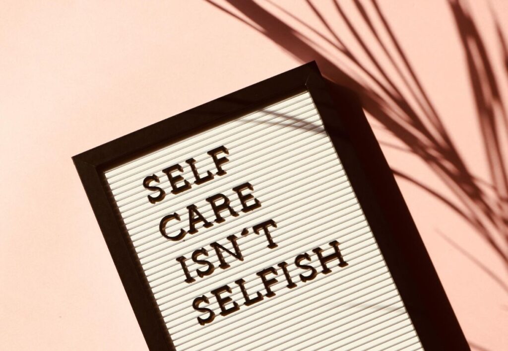 sign that says "self care isn't selfish" an important step in the stages of pet loss grief